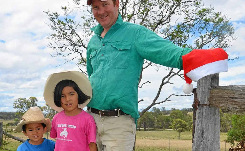 Hugh and Jia O'Dea with dad Andrew were pleased to see some rain.